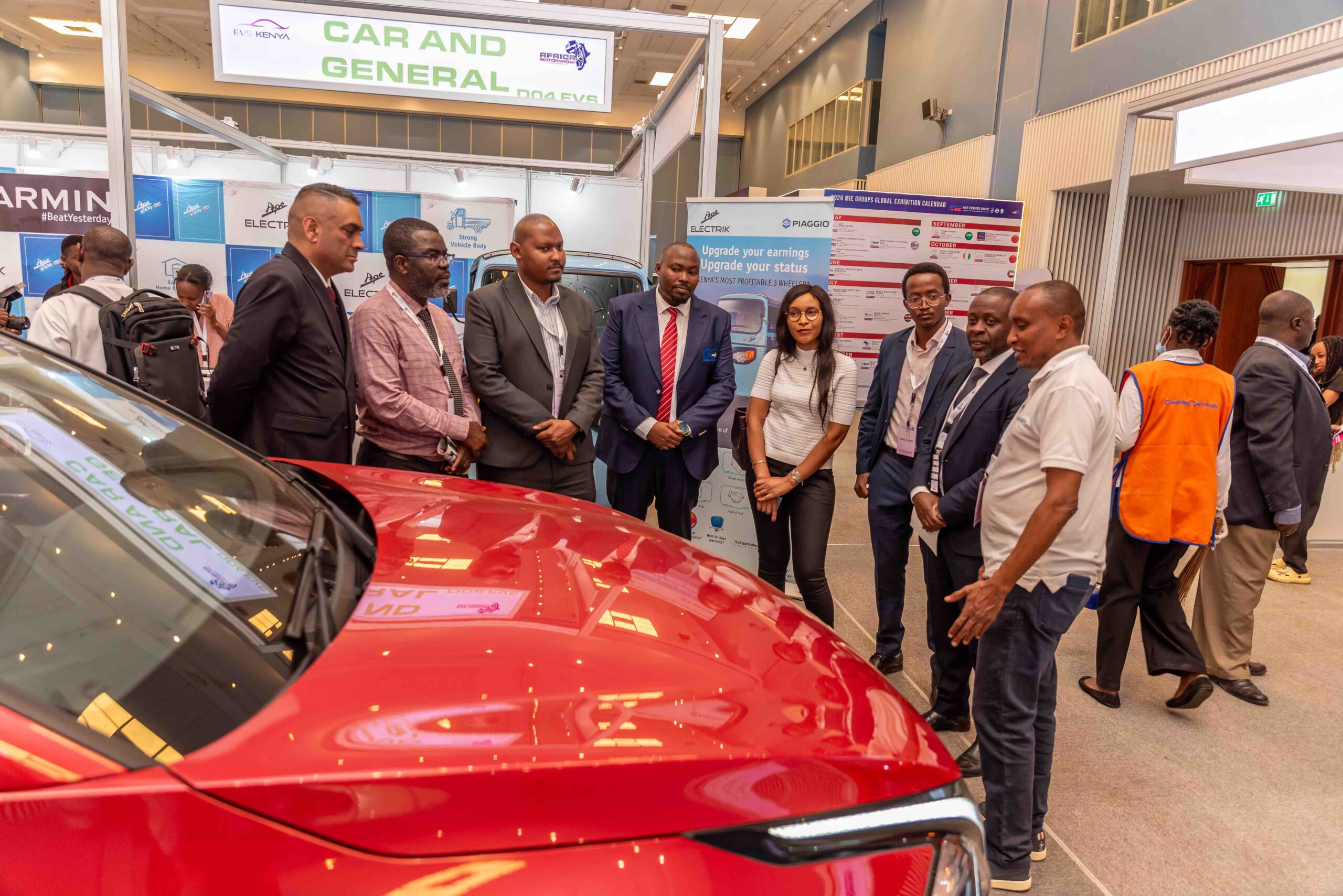 Visitors reviewing a vehicle on the expo floor